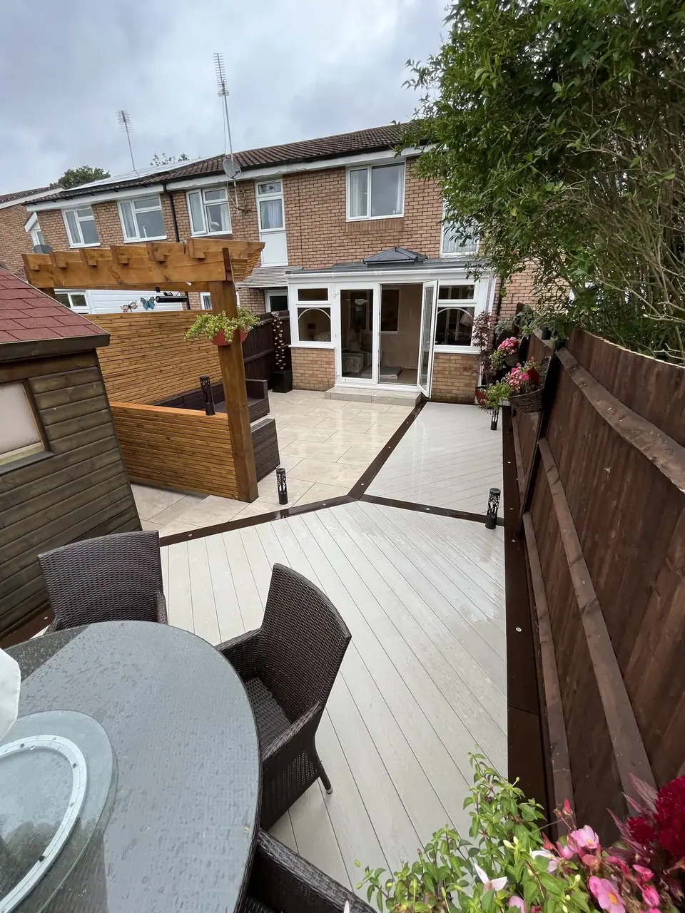 A view through a garden with paving, decking and outdoor seating