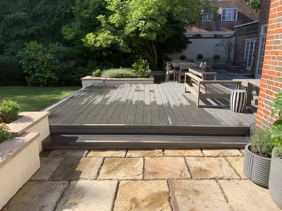 Wide deck steps meeting paving and planted edges
