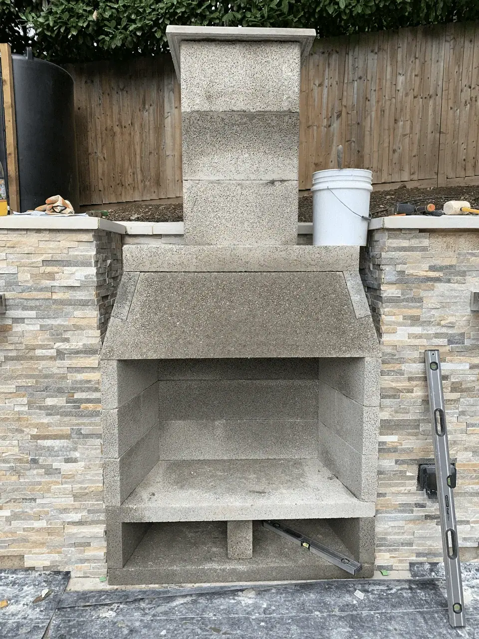 A masonry feature with stone facing during construction