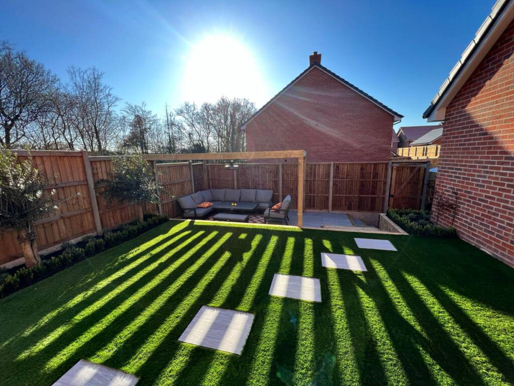 Beautifully lawned garden with decking area and outdoor seating, featuring a pagoda.